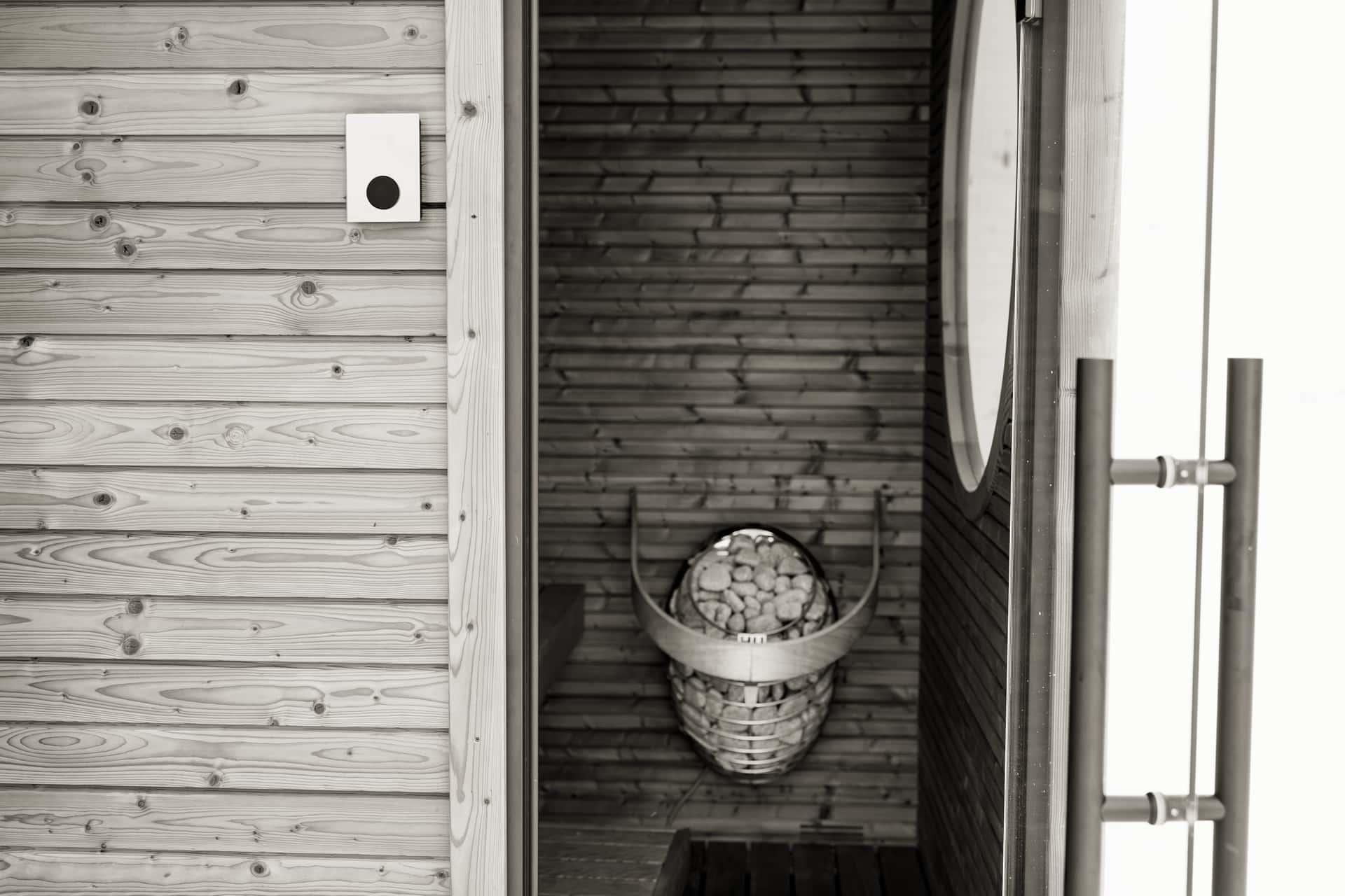 Interior of a three-person infrared sauna cabin with wooden benches