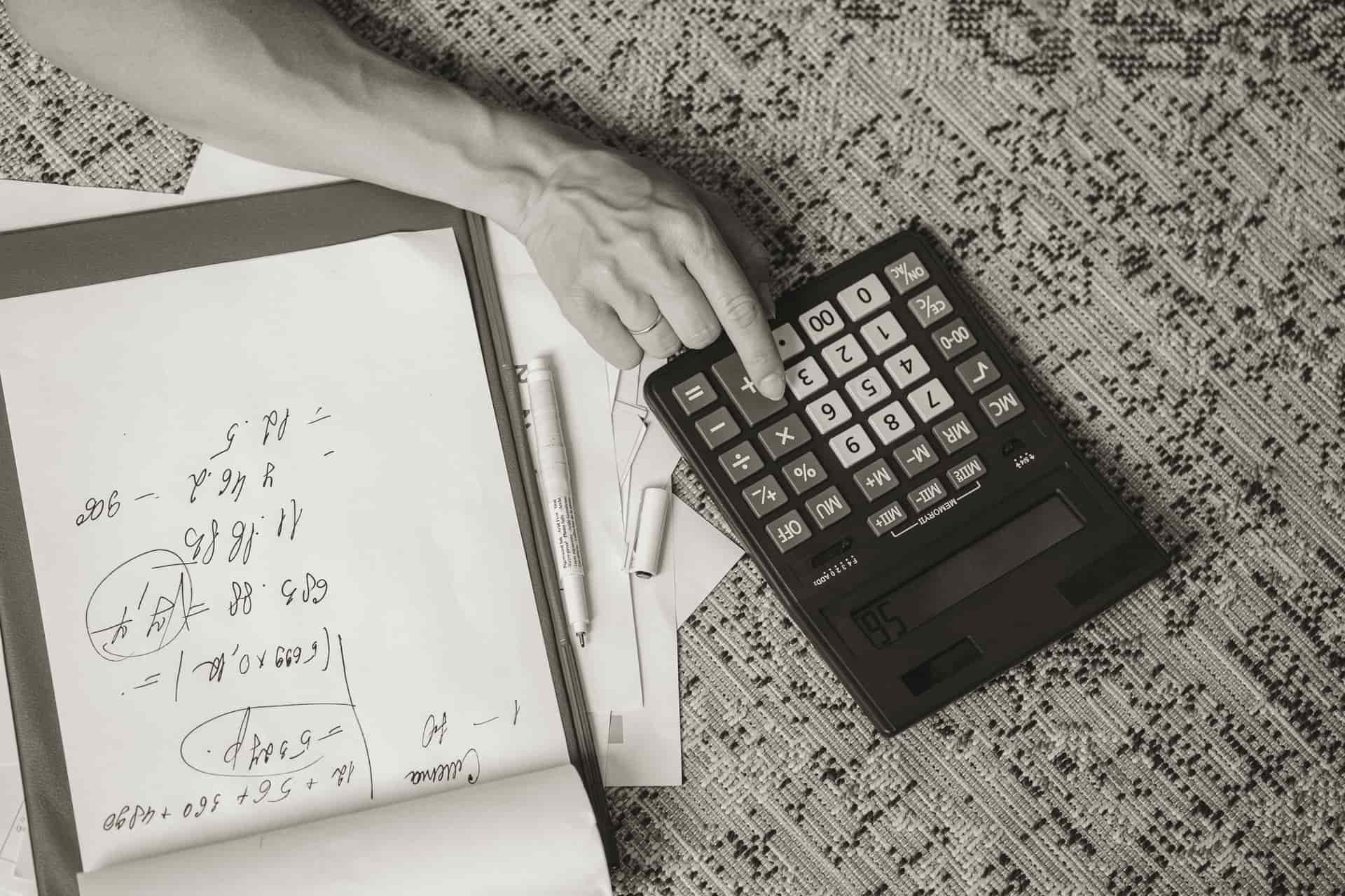 Calculator, notebook and figures on a desk