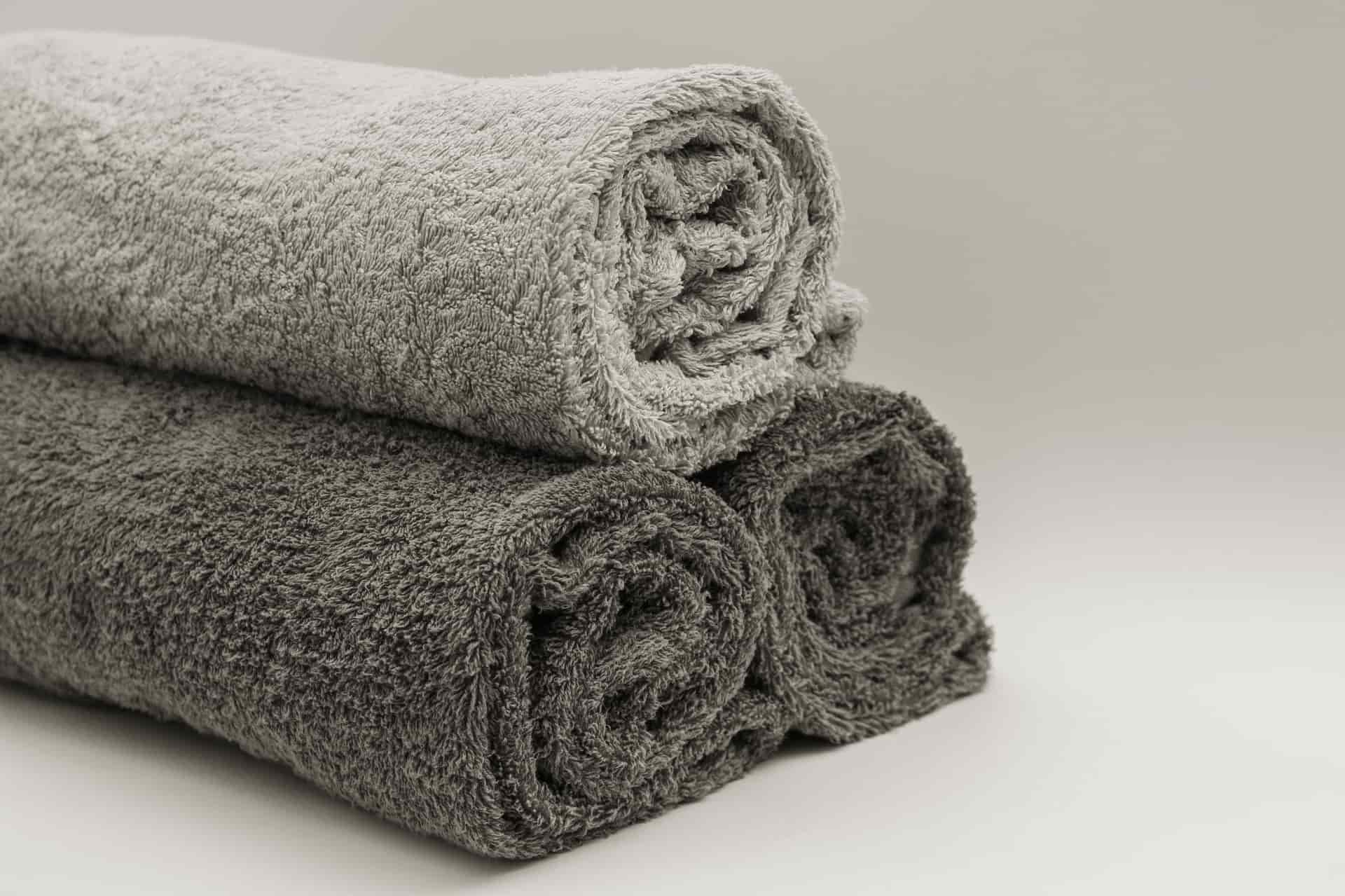 Folded towels and a wool hat in neutral tones