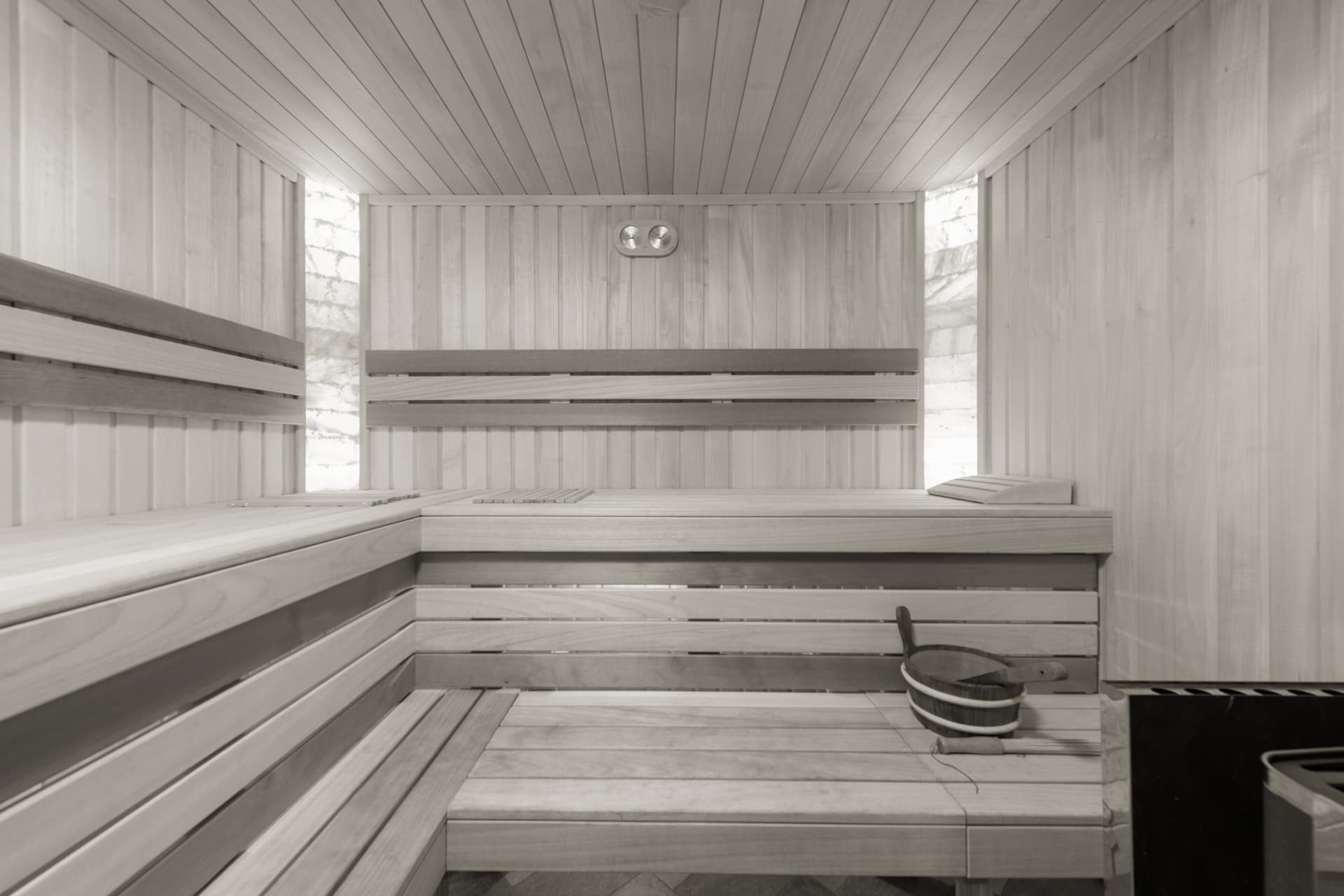 Cedar-lined sauna interior with bench seating and warm low lighting