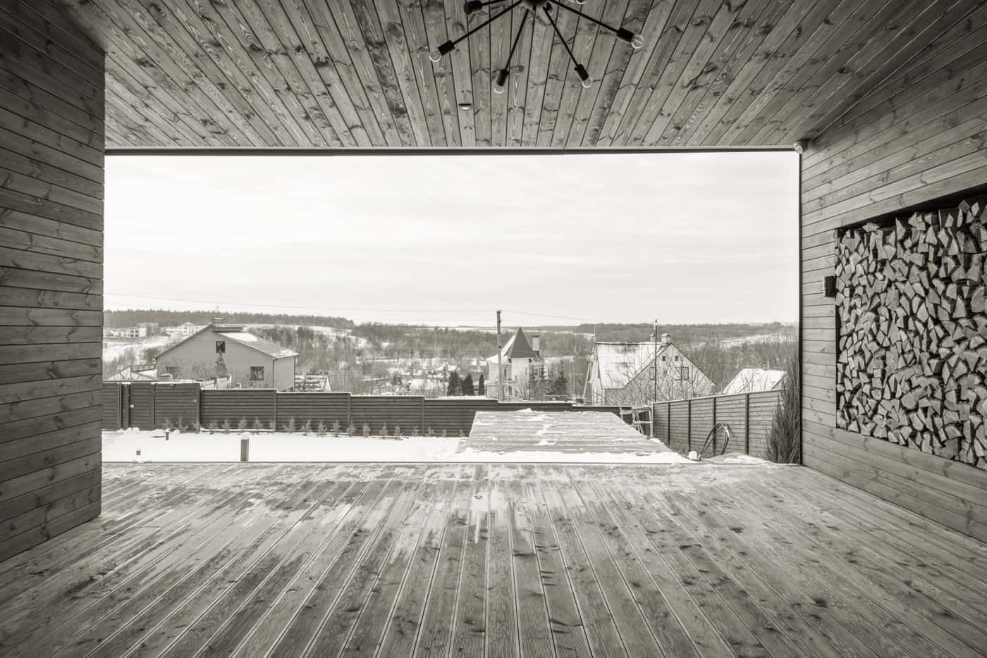 Wooden deck in snow beside a house